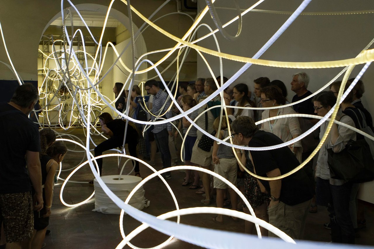 Grimanesa Amorós FORTUNA, 95 x 15 x 14-foot site-specific LED sculpture and light sculpture made of LEDs, diffusion and reflective material, and custom lighting sequence, installed within La Fragua of Tabacalera, the former Tobacco Factory of Embajadores, weaving the history of Spain's most celebrated tobacco factory into a luminous meditation on generosity, collective fortune, and the social act of sharing. Exhibited at Tabacalera Promoción del Arte, Ministry of Culture, Madrid, Spain, 2013.