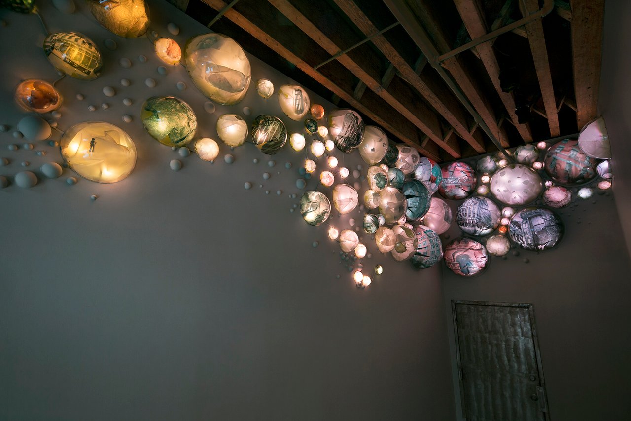 Grimanesa Amorós TERRARIUM, permanent 6 x 19 x 7-foot public art light sculpture and LED sculpture in the lobby of The Bayer Building, Tribeca, New York, 2005. Acrylic convex-lens bubble domes mounted on the walls radiate shifting patterns of light from dusk to dawn, their spherical forms containing photographs of the building's past, reflecting Tribeca's evolution from industrial landmark to residential community. LED art by Grimanesa Amorós.