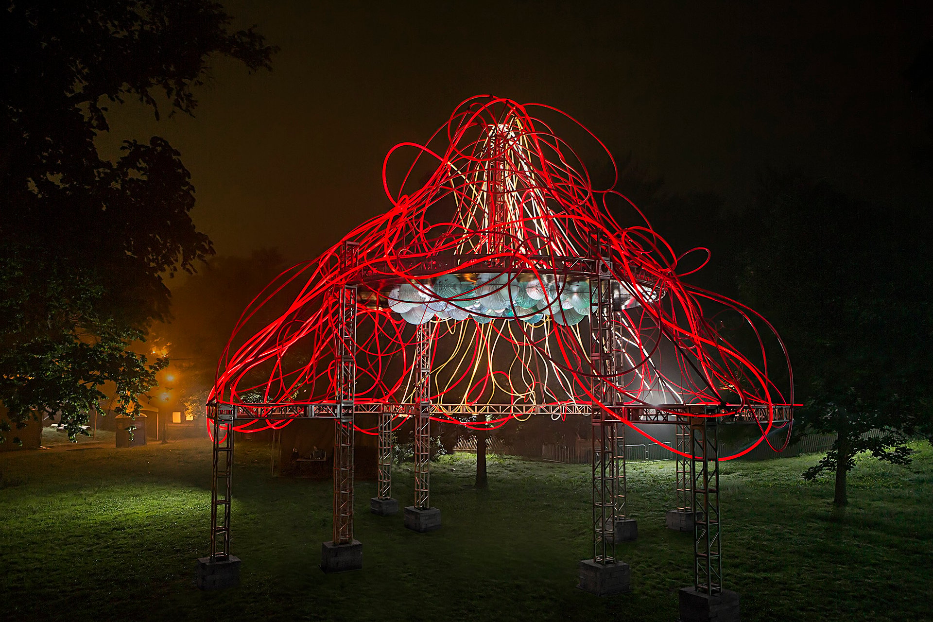 Grimanesa Amorós HEDERA — large-scale outdoor light sculpture and public art light sculpture at the Prospect Park Bandshell, BRIC, Brooklyn, NY. Over 2,000 square feet of glowing ivy-like LED art transitions from translucent white to deep red, while reflective domes shift from aquamarine blue to ruby red. Light sculpture outdoor installation by Grimanesa Amorós.