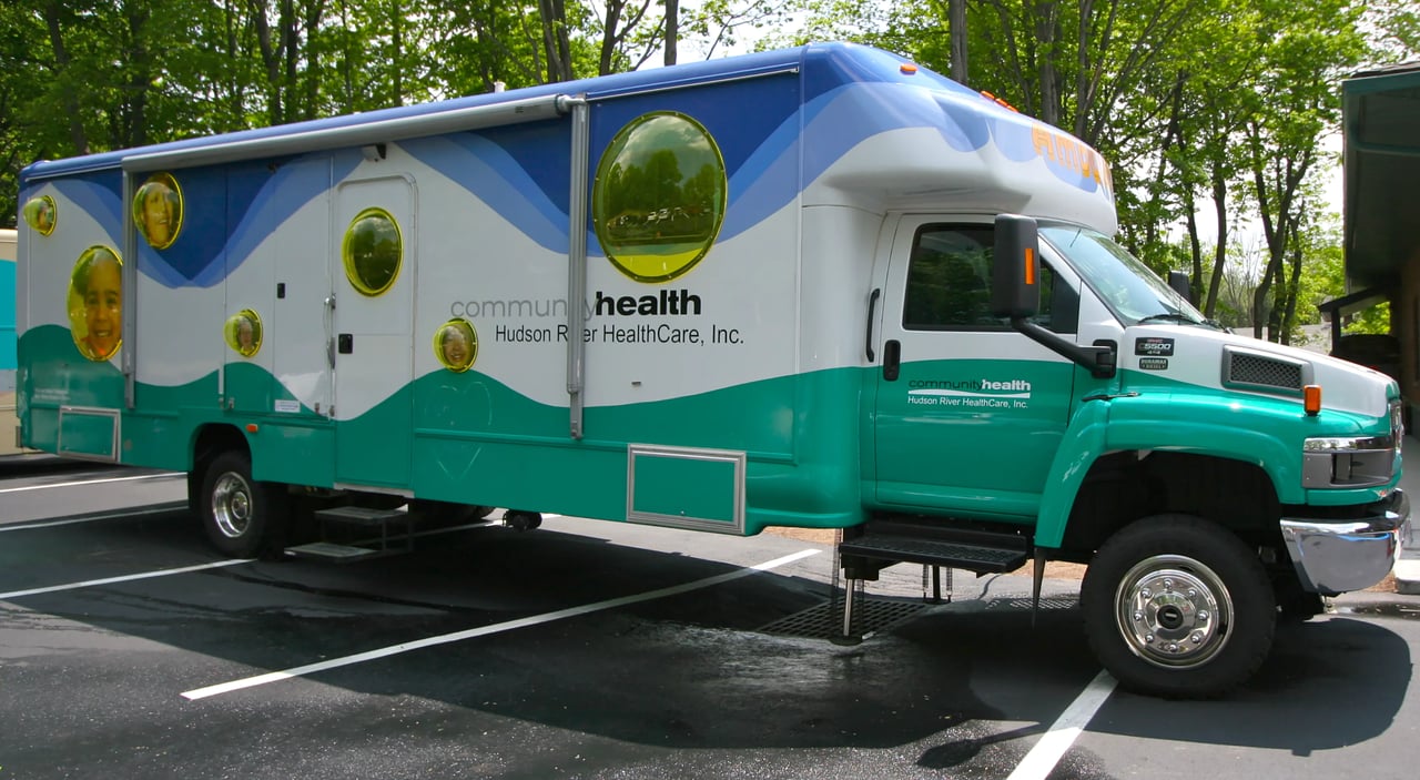 Grimanesa Amorós AMBULANTE, site-specific community artwork on a mobile dental clinic for HRHCare, New York, 2005. Playful acrylic bubble forms containing community portraits adorn the exterior of the van, with teal chalkboard paint on the lower panels inviting children to draw, inspired by the street vendors of Lima, Peru. Site-specific community artwork by Grimanesa Amorós.