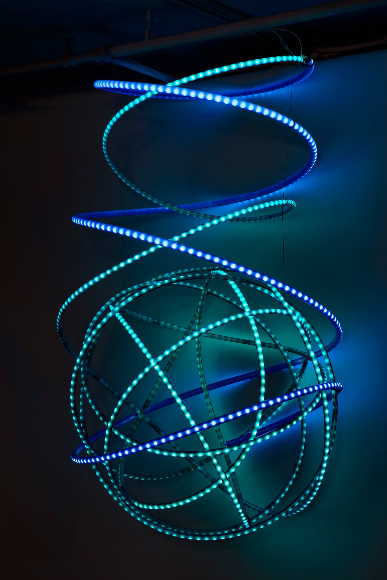 Grimanesa Amorós AZULIN, 87 x 77 x 120-inch light sculpture made of LEDs, diffusion material, and custom lighting sequence, inspired by the mangroves of Central America, its twisting and turning forms encapsulating the viewer and luring them deeper like the dense interlaced branches of the mangrove tempt exploration along tropical coastlines. Light sculpture by Grimanesa Amorós, 2022.