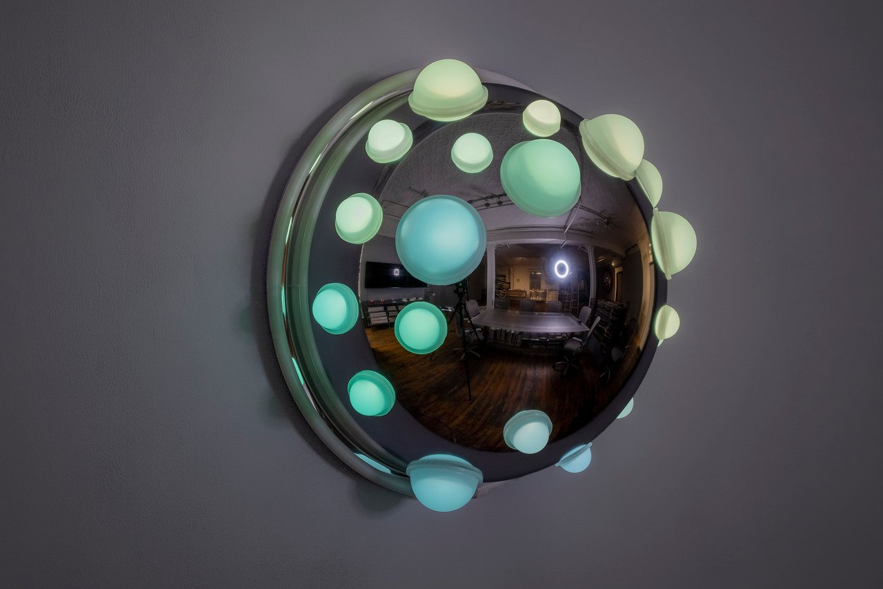 Grimanesa Amorós LUMINOUS PORTRAITS 6, 26 x 26 x 14-inch light sculpture made of stainless steel, diffusion and reflective material, LEDs, and custom lighting sequence, a limited edition series blending vibrant colors and geometric designs from Pre-Columbian textiles and ceramics with smooth metallic textures and futuristic shapes, exploring the relationship between Incan sun ceremonies and the futurist aesthetic and the influence of tradition on our collective future. Light sculpture by Grimanesa Amorós, 2024.