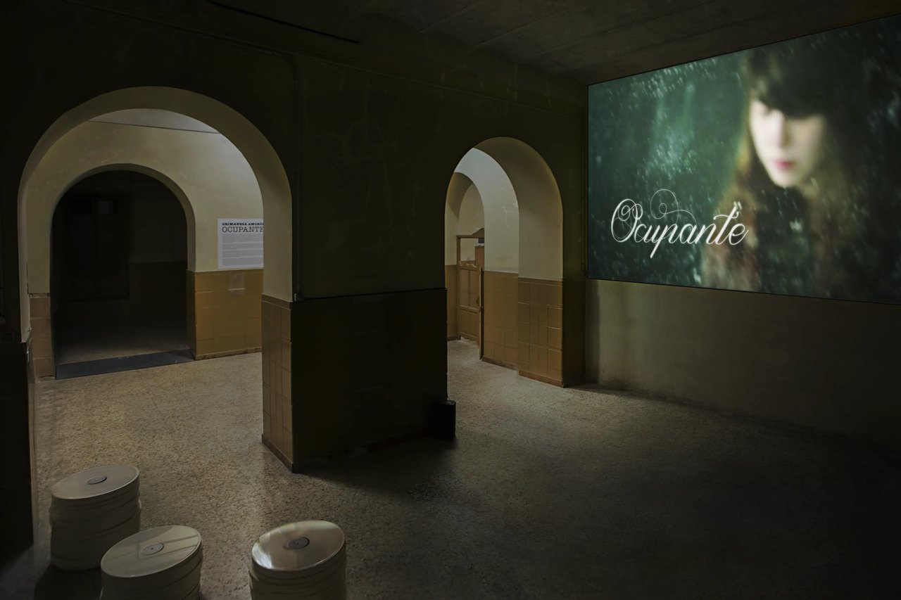 Grimanesa Amorós OCUPANTE, single channel video, 5 min 12 sec, featuring the Lisbon Gulbenkian Foundation Orchestra with guitarist Sharon Isbin, flutist Carol Wincenc, composers Tan Dun and Joan Tower, and conductor Muhai Tang, 2014. Organized by Tabacalera Promoción del Arte and the Spanish Ministry of Education, Culture, and Sports, and curated by Mariflor Sanz and Durga Blázquez. Exhibited at Tabacalera, Madrid, Spain, 2018.