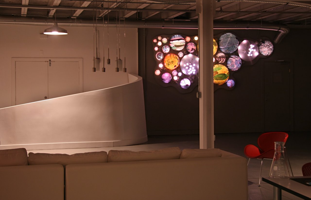Grimanesa Amorós TERRAFORMS, 6 x 12 x 1-foot site-specific LED sculpture and light sculpture at The Lab advertising agency, Miami, Florida, 2006. Made of acrylic, convex lens, LEDs, and custom lighting sequence, the work draws on the scientific theory of terraforming and the bird's-eye visual patterns of circular irrigated fields, Incan terraced steps at Machu Picchu, and aerial farmland, meditating on humanity's reshaping of natural environments for survival. LED light art by Grimanesa Amorós, presented in conjunction with lemon sky: projects + editions.