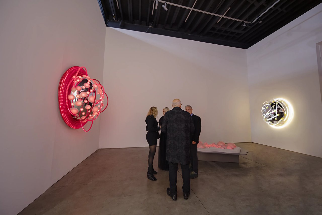 Grimanesa Amorós LOTUS, LED sculpture and light sculpture made of stainless steel, diffusion and reflective material, LEDs, and custom lighting sequence, its warm tonal LED sequence shifting through the gradual opening of a lotus blossom from bud to full bloom, channeling the lotus flower's ancient symbolism of resilience, transformation, and rebirth to honor the enduring strength of women. Exhibited as the centerpiece of WOMEN, a group exhibition held in recognition of Breast Cancer Awareness Month, at Richard Taittinger Gallery, New York, 2022.