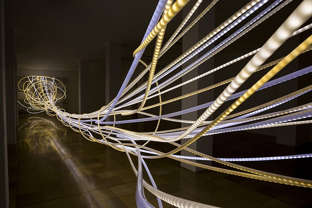 Grimanesa Amoros' Ocupante installation at the Ludwig Museum in Berlin, Germany uses a vortex of light strips to help the viewer become an occupant of the space and embody the dream of a connected world.